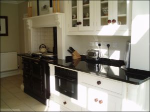 Image Of Absolute Black Granite Kitchen Dresser And Oven